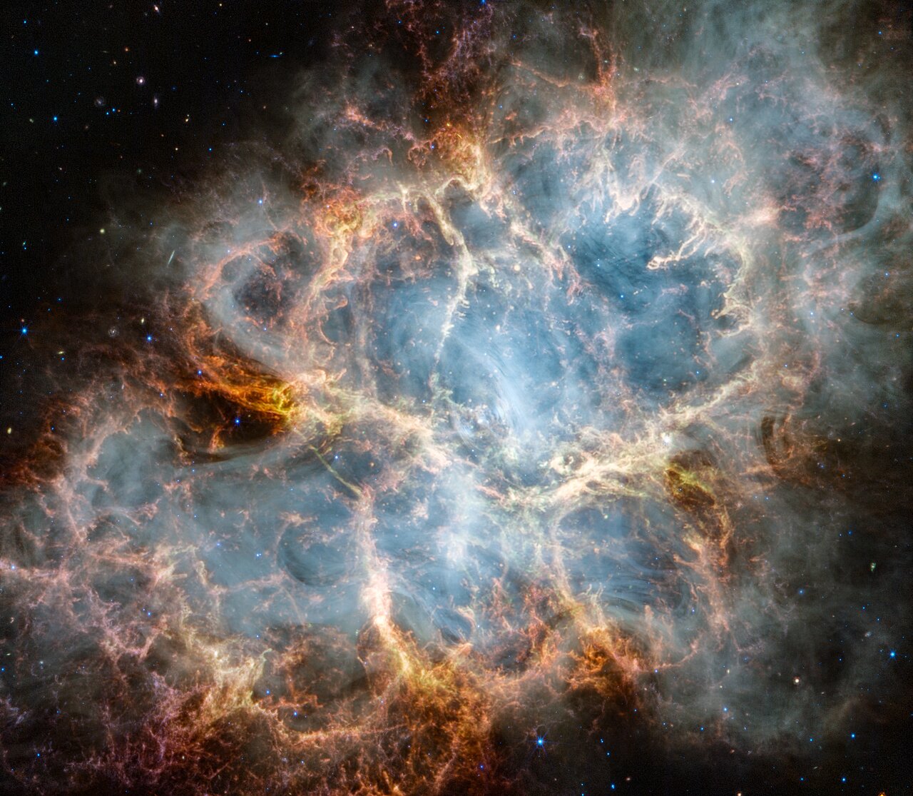 The Crab Nebula in infrared: a cage of orange and red filaments around a glowing white-blue interior